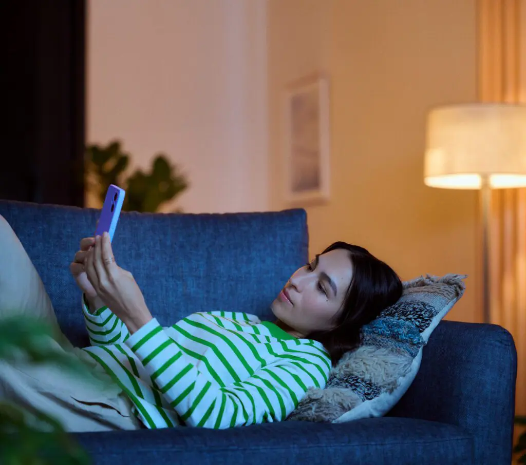 Cheerful student watching their favorite shows through StreamSaver on the Xfinity network.