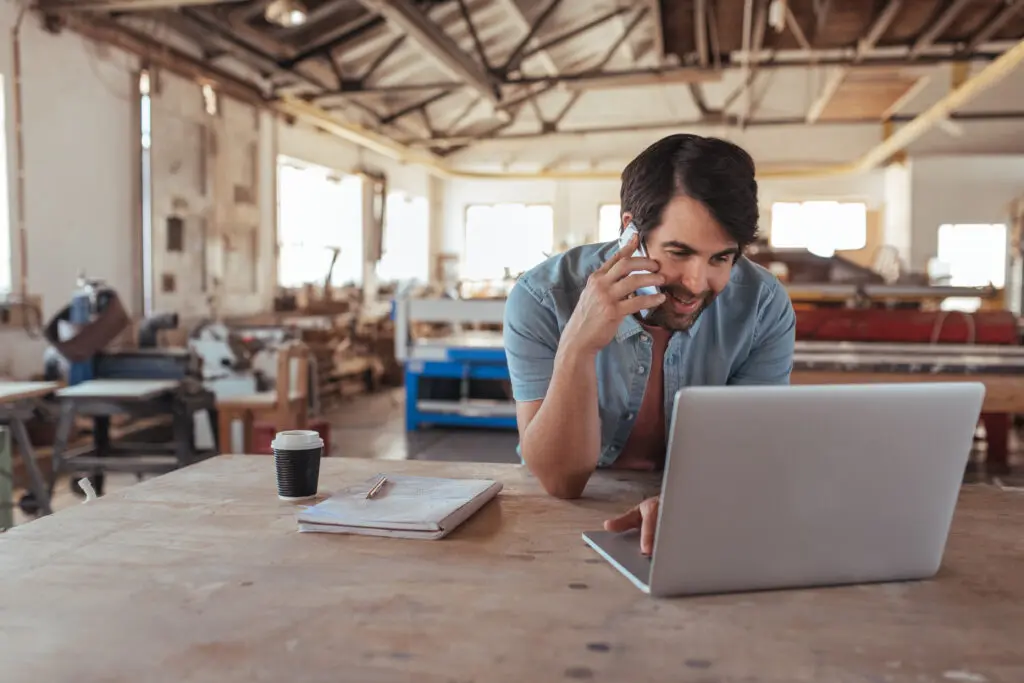 Small businesses in Illinois utilize Comcast Business to run their organization with fast, secure and reliable Internet and power their mobile devices. IMAGE: A local Illinois woodworking shop with employees on cell phones and tablets.