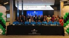 Participants in the “Youth-to-Career Link” (CY2CL) program sit at a long table.