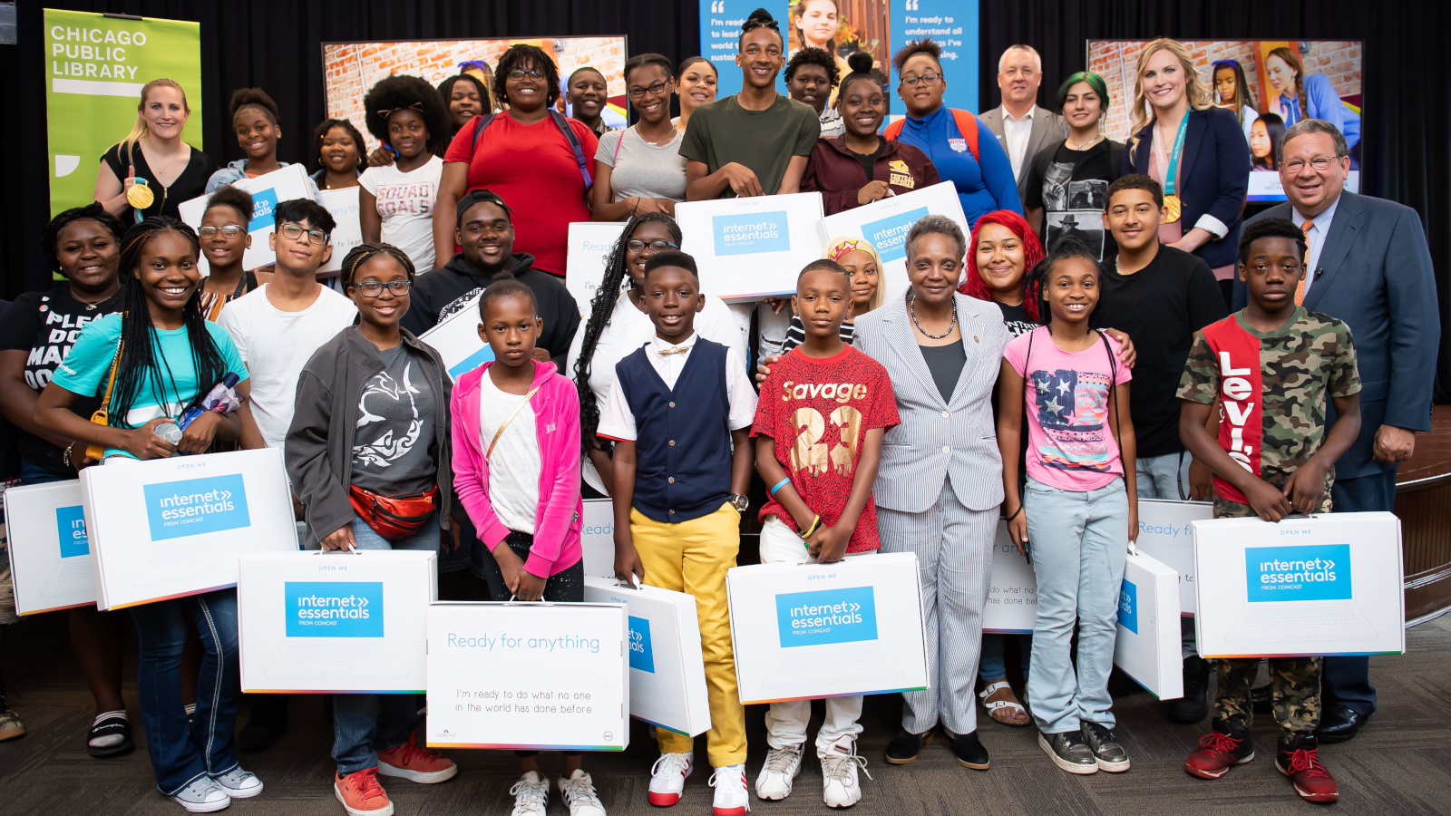 A group of children receive Internet Essentials laptops at an event in Chicago.