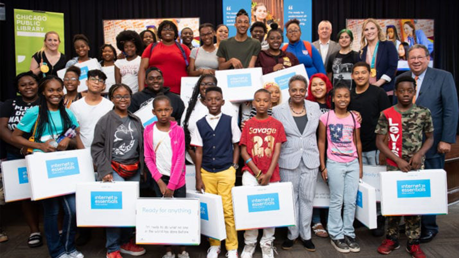 A group of children receive Internet Essentials laptops at an event in Chicago.