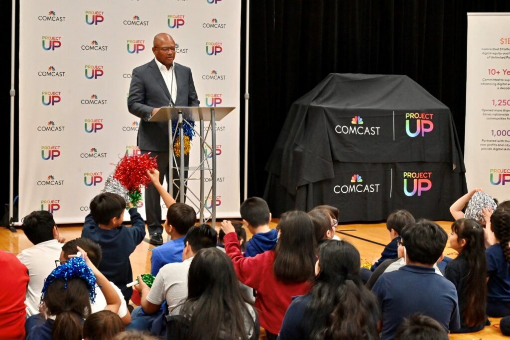 Broderick Johnson at Little Village Boys & Girls Club announcing donation of laptops.