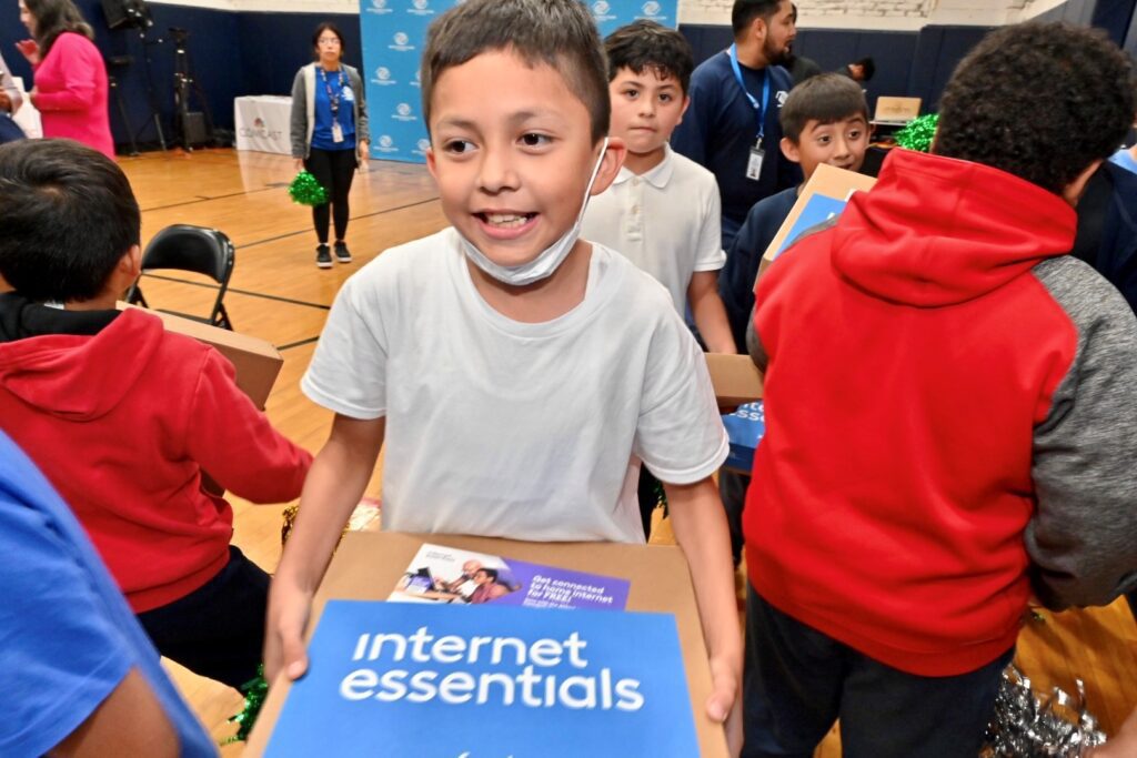 Club member holding a new laptop.