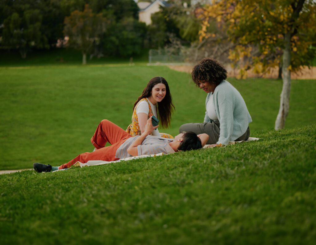 Group using phone at the park